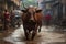 a bull running through a muddy street with people in the background