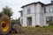 bulldozer is being prepared to demolish an illegally built private house in a natural area. Close - up photo of a tractor bucket