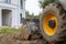 bulldozer is being prepared to demolish an illegally built private house in natural area. Close - up photo of tractor bucket in