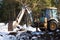 Bulldozer bucket close-up digs a pit for the construction. The foundation of the house, earthworks. The excavator shovels out the