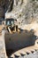 Bulldozer in a Carrara marble quarry. A large  mechanical shovel