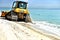 Bulldozer cleaning beach after storm florida usa