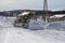 The bulldozer cleans the road from the snow on the street.