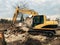 Bulldozer clearing land from old bricks and concrete from walls with dirt and trash. Backhoe machinery ruining house. Excavator