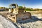 Bulldozer during the construction of a new road. Top view of a powerful working bulldozer. Earthmoving equipment for road works,