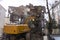 Bulldozer demolishes old buildings. demolition of a building in the harbor area