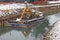 Bulldozer Digger in a barge during the work of the River