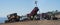 Bulldozer and Dump truck unloading dirt on Goleta Beach, California.