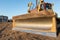 Bulldozer during earthmoving works at construction site