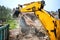 Bulldozer and excavator demolishing concrete walls