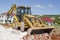 Bulldozer With Jackhammer Working Across Trench