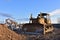 Bulldozer at landfill for work concrete demolition waste. Salvaging and recycling construction materials. Dozer destroys concrete