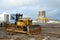 Bulldozer during of large construction jobs at building site. Crawler tractor dozer for earth-moving.