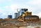Bulldozer during of large construction jobs at building site. Land clearing, gr