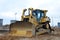 Bulldozer during of large construction jobs at building site. Land clearing, grading, pool excavation, utility trenching