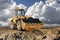 Bulldozer or loader against a cloudy sky. An earthmoving machine is leveling the site. Construction equipment for earthworks.