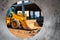 Bulldozer or loader moves the earth at the construction site against the blue sky. An earthmoving machine is leveling the site.