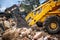 Bulldozer loading demolition debris and concrete waste