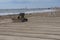 A bulldozer maintains a beach