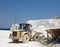 Bulldozer at marble quarry on island