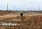 Bulldozer moves gravel during on road work at construction site. Dozer leveling stones for laying asphalt on a new freeway. Heavy