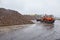 Bulldozer moves parts of sugar beet at sugar factory