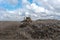 Bulldozer moving waste on a landfill site