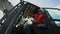 Bulldozer operator in white hardhat and orange vest seated in cabin