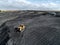Bulldozer is pushing hard coal. Large coal heap.