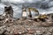 Bulldozer removes the debris from demolition of derelict buildings