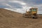 Bulldozer at revitalization of landfill