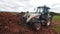 Bulldozer takes dirt with bucket at open construction site