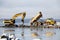 Bulldozer and truck in dredging works