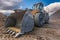 Bulldozer type excavator working in a rock and stone processing plant for gravel processing