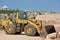 Bulldozer on wheels shovels large stones