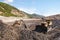 The bulldozer works in mountainous areas.  Open pit mining natural gold in mountainous, wooded areas.