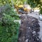 Bulldozer works on the repair of the intra-block road and sidewalk