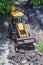 Bulldozer works on the repair of the intra-block road and sidewalk