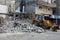 Bulldozers remove the debris from the  building, that was hit by Israeli air strikes during the Israeli-Palestinian conflict in Ma