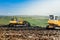 bulldozers working on construction site. Details of wasteland, garbage disposal dumping grounds