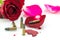 Bullet on blood and red rose on white background