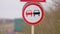 Bullet holes on a road sign overtaking prohibited. Dangerous turn. Close-up shot. Ukraine sign after shelling War in