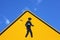 Bullet holes in stick figure of yellow road sign