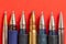 Bullet and pens on red background. Freedom of the press is at risk concept. World press freedom day concept