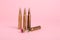 Bullets and beautiful chrysanthemum flower on pink background
