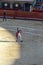 A bullfighter is walking out of the arena after a corrida