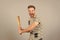 Bully man shouting aggressive face, grey background. Man with wooden bat ready to attack. Aggressive behaviour concept