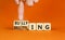 Bullying and belittling symbol. Concept words Bullying and Belittling on wooden cubes. Businessman hand. Beautiful orange table