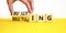 Bullying and belittling symbol. Concept words Bullying and Belittling on wooden cubes. Businessman hand. Beautiful yellow table