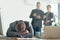 Bullying finds its way into the workplace. a dejected businessman lying on his arms at his desk while his colleagues